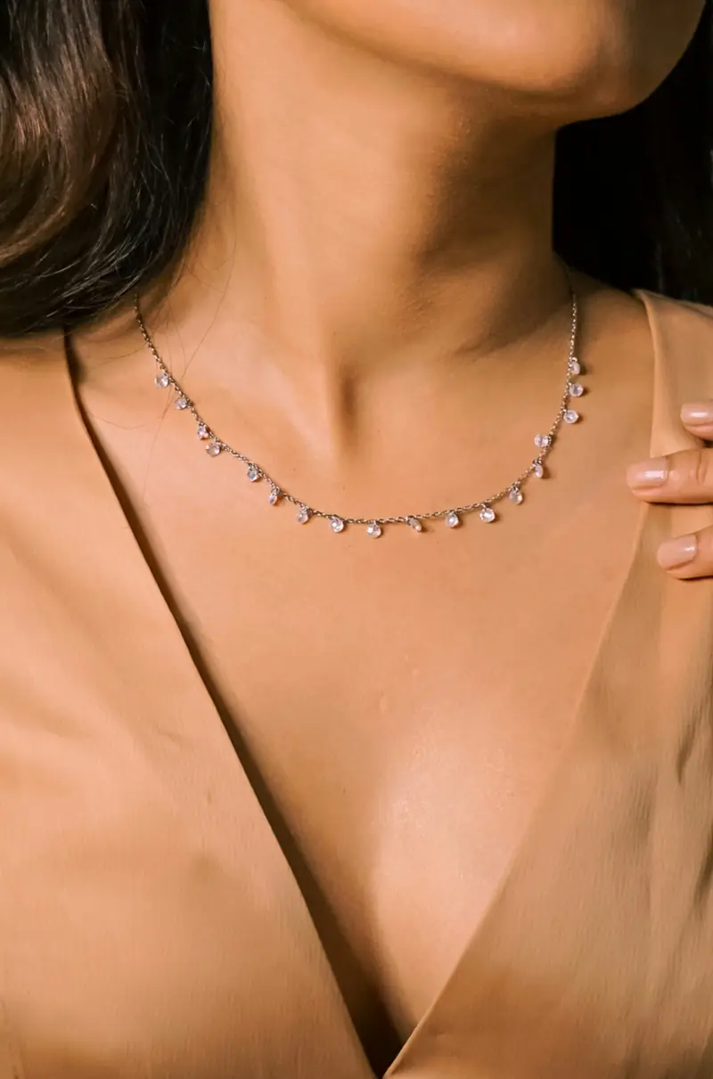 A fine diamond station necklace worn at the collarbone