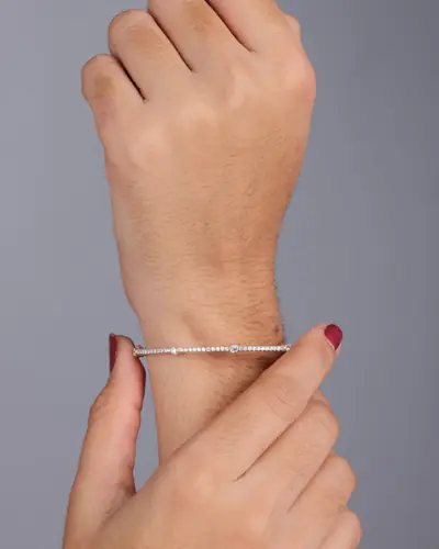 A slim diamond-set bangle worn on a wrist